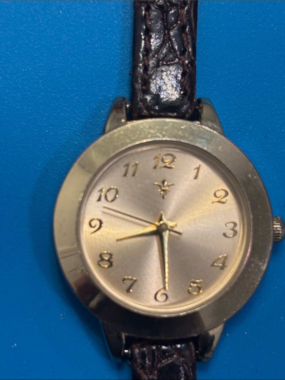 REI gold and brown women's analog wristwatch
